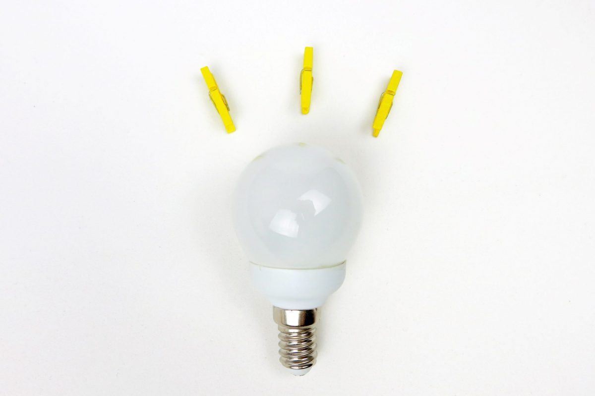 Lightbulb with yellow clothespins representing light rays